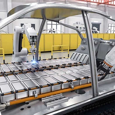car manufacturing line placing batteries into frame